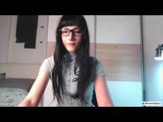 a bespectacled brunette performs perverted acts on camera.